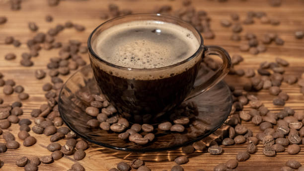 istock Coffee cup and coffee beans on wooden table. Selective focus 1188038526