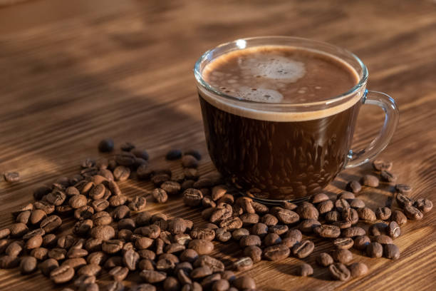 istock Coffee cup and coffee beans on wooden table. Selective focus 1188038647