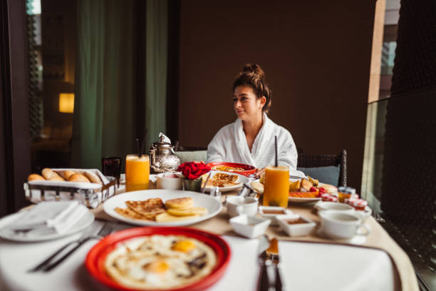 istock woman at the table for the buffet breakfast with fruit 1188038677