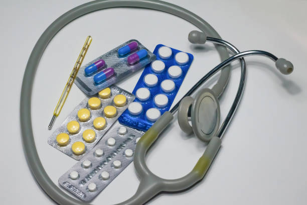 istock close up of thermometer, tablets and capsules 1188038694