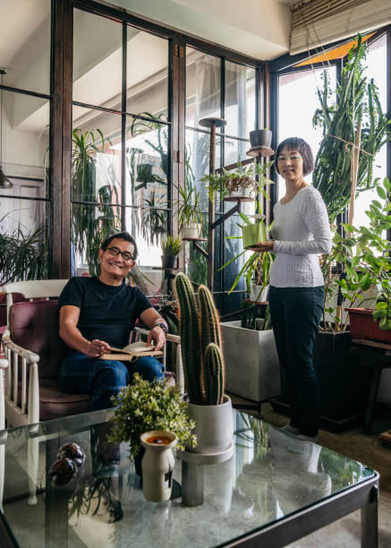 istock Cheerful Chinese couple relaxing in conservatory with plants 1188040482
