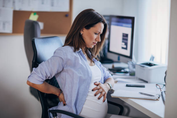 istock Pregnant woman feeling back pain while working 1188041646