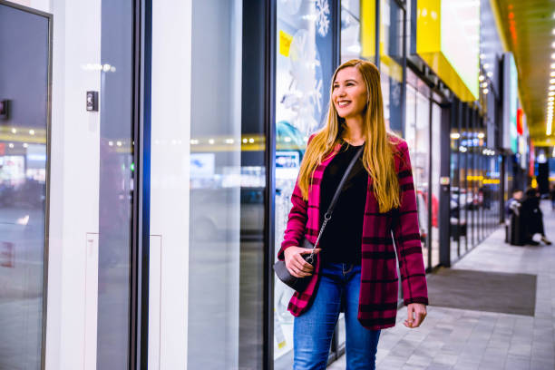 istock Woman looking through shop window 1188041809
