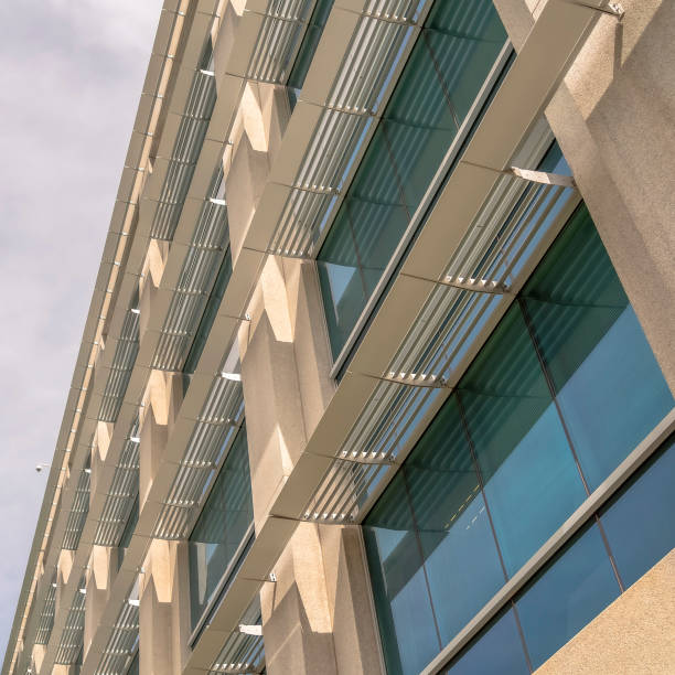 istock Square frame Modern office building exterior viewed against cloudy sky on a sunny day 1188042118