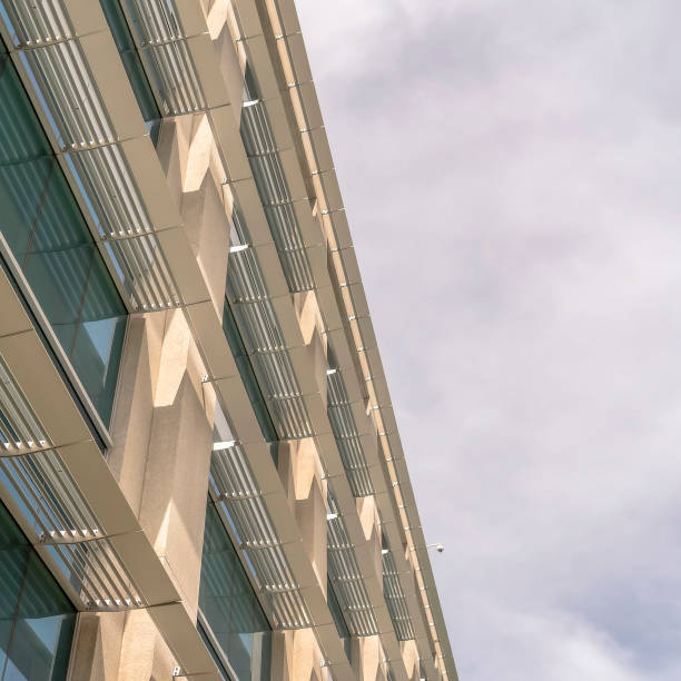 istock Square Modern office building exterior viewed against cloudy sky on a sunny day 1188043381