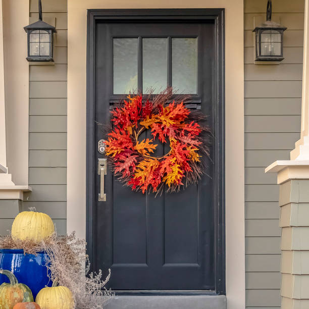 istock Square Colorful autumn wreath hanging on a front door 1188043872