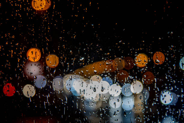 istock rain drops and colorful traffic bokeh 1188046506