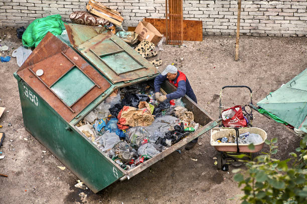 homeless rummaging in the trash. - tailings container environment pollution imagens e fotografias de stock