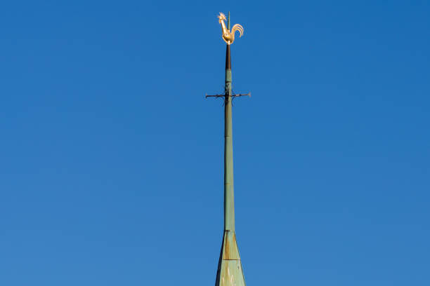steeple weathercock on summer sunny day and blue sky