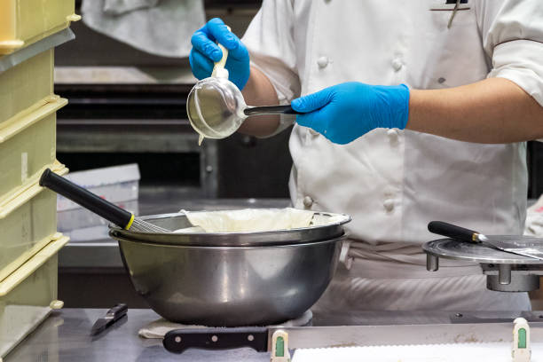 istock A male pastry chef using a spatula and ladle while making whipped cream 1188056826