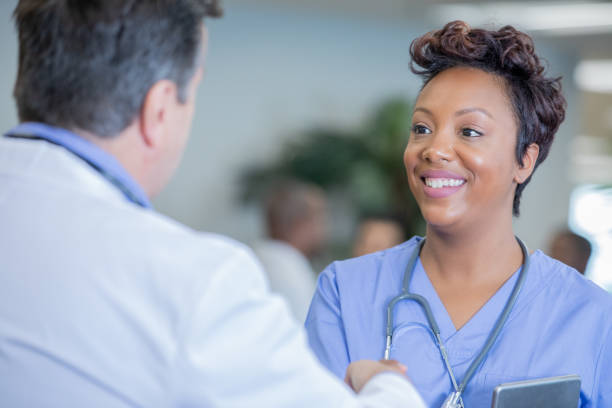 istock Nurse talking with doctor about lab results on digital tablet 1188058963