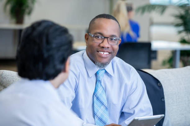 istock Professional businessman using digital tablet in meeting with client 1188058973