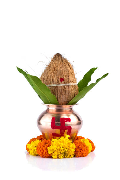 istock Copper Kalash with coconut and mango leaf and pooja thali with diya, kumkum and sweets with floral decoration on a white background. Essential in hindu puja. 1188059017