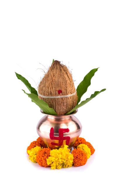 istock Copper Kalash with coconut and mango leaf and pooja thali with diya, kumkum and sweets with floral decoration on a white background. Essential in hindu puja. 1188059033