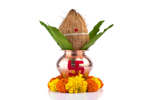 istock Copper Kalash with coconut and mango leaf and pooja thali with diya, kumkum and sweets with floral decoration on a white background. Essential in hindu puja. 1188059180