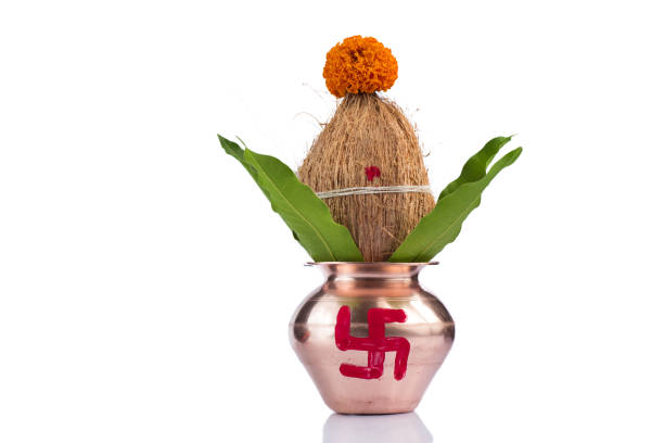 istock Copper Kalash with coconut and mango leaf with floral decoration on a white background. Essential in Hindu Puja. 1188059189