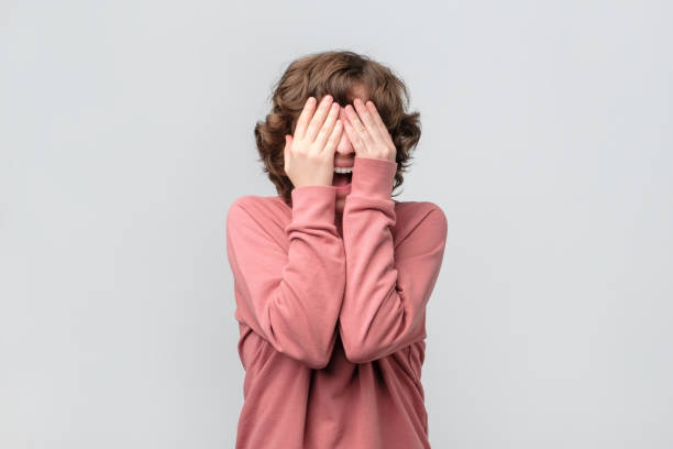 istock woman closing her eyes with hand, having happy expression, recieving present 1188059991