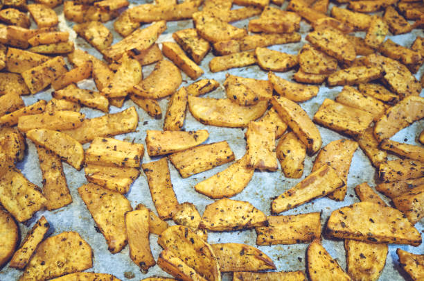 istock Roasted sweet potatoes with herbs on baking paper. 1188061531