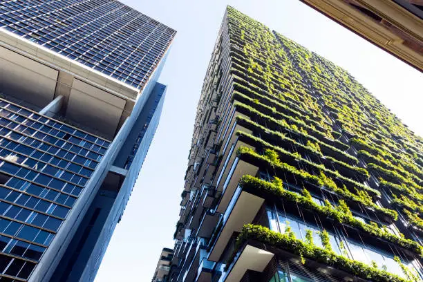 Low angle view of apartment building with vertical garden, sky background with copy space, Green wall-BioWall or living wall is a wall covered with living plants on residential tower in sunny day, Sydney Australia, full frame horizontal composition