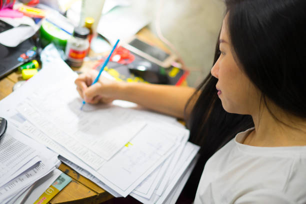 istock Young asian woman hard working at home 1188063617
