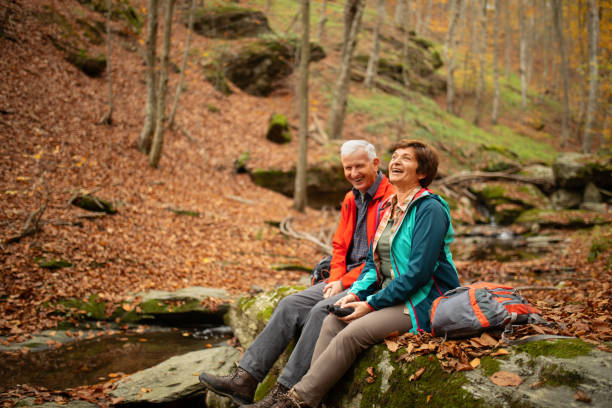 istock Senior couple going hiking in forest on mountain 1188064249