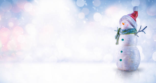 istock Snowman Against Abstract Defocused Backdrop with Copy Space 1188064543