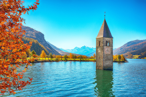 Fantasic autumn view of submerged bell tower in lake Resia.