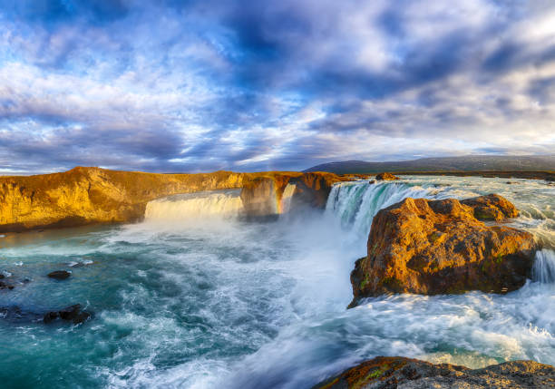 Breathtaking sunset landscape scene of powerful Godafoss waterfall. Dramatic sky over Godafoss. Location: Bardardalur valley, Skjalfandafljot river, Iceland, Europe