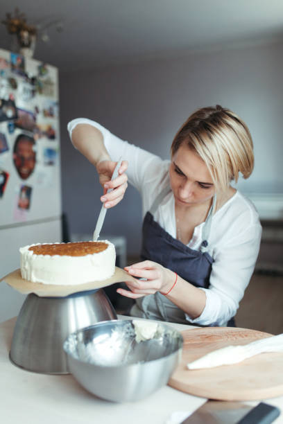A middle aged woman confectioner or baker. stock photo