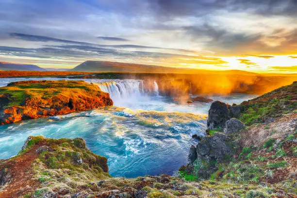 Fantastic sunrise scene of powerful Godafoss waterfall. Dramatic sky over Godafoss. Location: Bardardalur valley, Skjalfandafljot river, Iceland, Europe