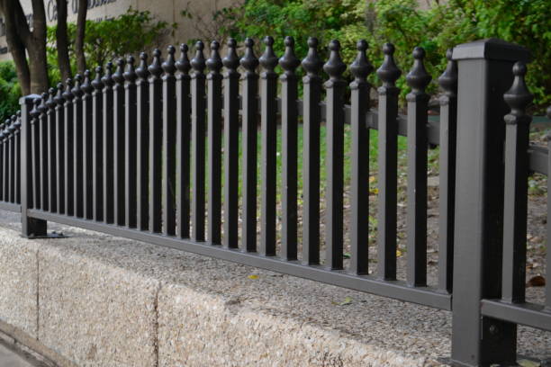 istock Iron Fence Over A Concrete Wall 1188082683