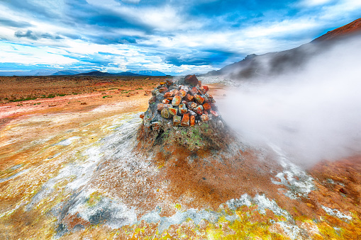 Steaming cone in Hverir geothermal area with boiling mudpools and steaming fumaroles in Iceland  Location: geothermal area Hverir, Myvatn region, North part of Iceland, Europe