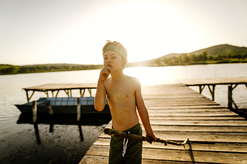 Photo of a cute, little boy on a lake