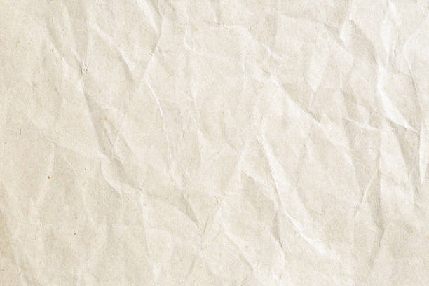 istock Old pale brown crumpled paper background texture 1188089225