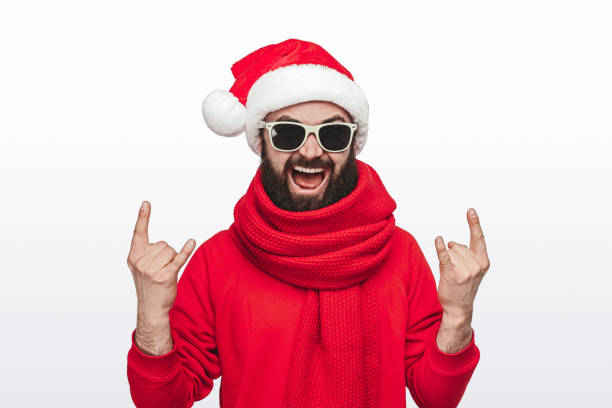 istock Man in Santa hat gesturing horns 1188089291