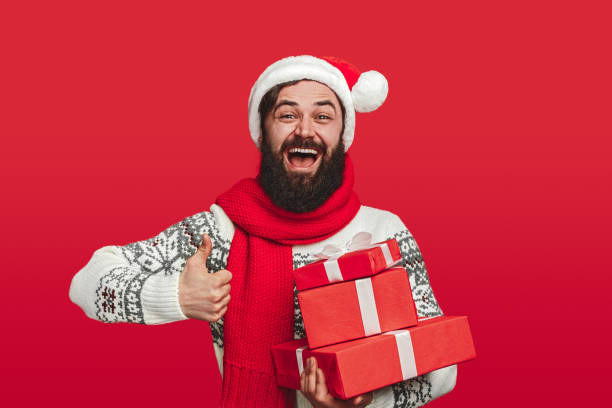 istock Optimistic bearded male approving Christmas gifts 1188089303