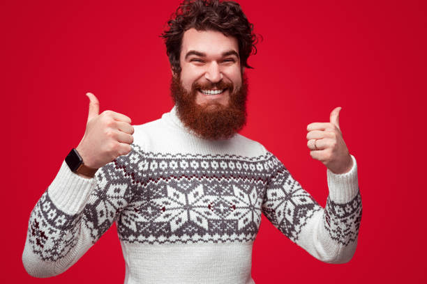 istock Bearded happy man in sweater holding thumbs up 1188089309