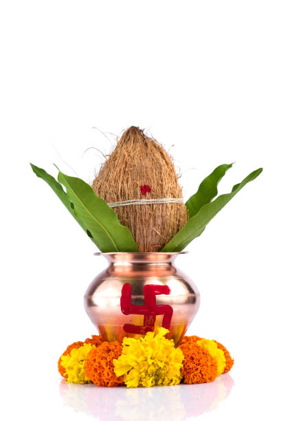 istock Copper Kalash with coconut and mango leaf with floral decoration on a white background. Essential in Hindu Puja. 1188093526