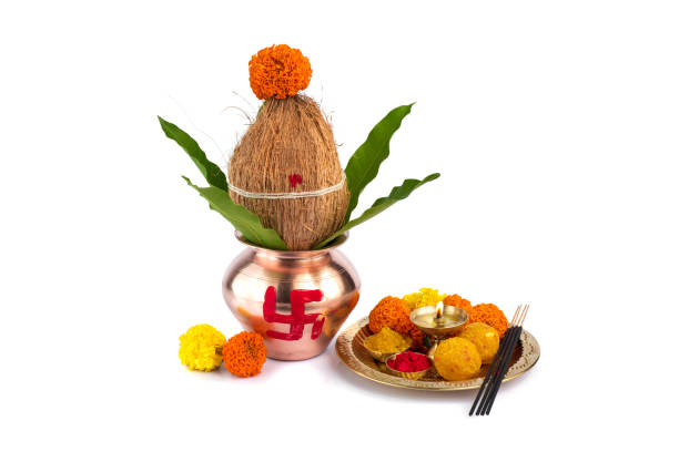 istock Copper Kalash with coconut and mango leaf and pooja thali with diya, kumkum and sweets with floral decoration on a white background. Essential in hindu puja. 1188093564