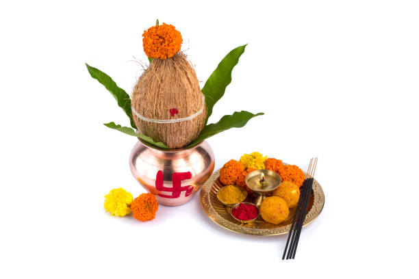 istock Copper Kalash with coconut and mango leaf and pooja thali with diya, kumkum and sweets with floral decoration on a white background. Essential in hindu puja. 1188094122