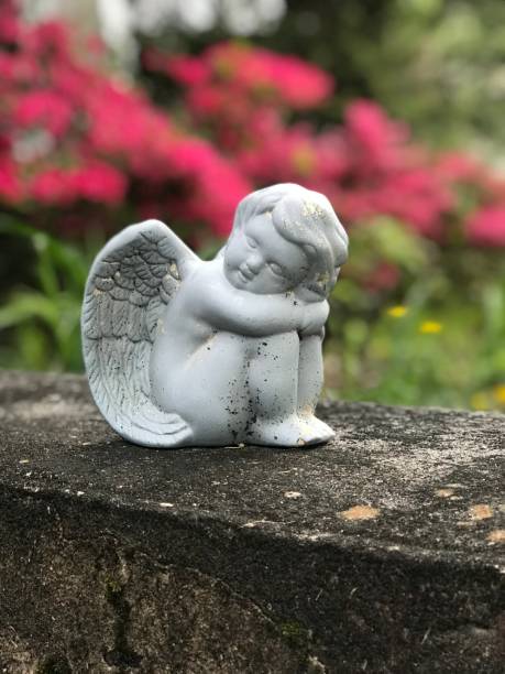 istock Garden angel in a wall in the spring 1188094192