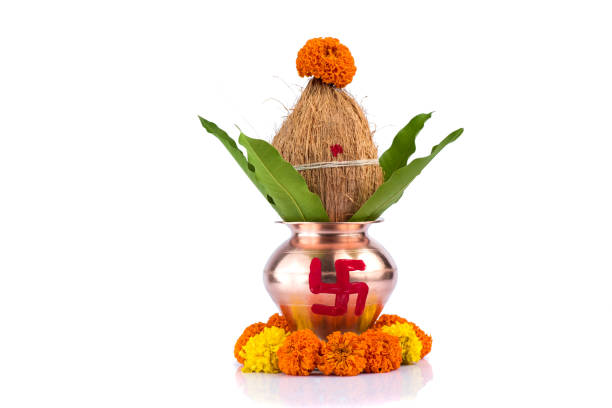 istock Copper Kalash with coconut and mango leaf with floral decoration on a white background. Essential in Hindu Puja. 1188094621