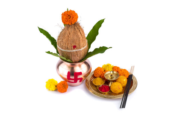 istock Copper Kalash with coconut and mango leaf and pooja thali with diya, kumkum and sweets with floral decoration on a white background. Essential in hindu puja. 1188096731