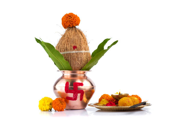 istock Copper Kalash with coconut and mango leaf and pooja thali with diya, kumkum and sweets with floral decoration on a white background. Essential in hindu puja. 1188099831