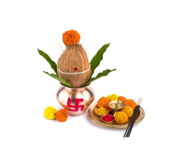istock Copper Kalash with coconut and mango leaf and pooja thali with diya, kumkum and sweets with floral decoration on a white background. Essential in hindu puja. 1188099921