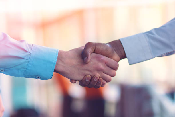 istock Handshake between african and a caucasian man. 1188099946