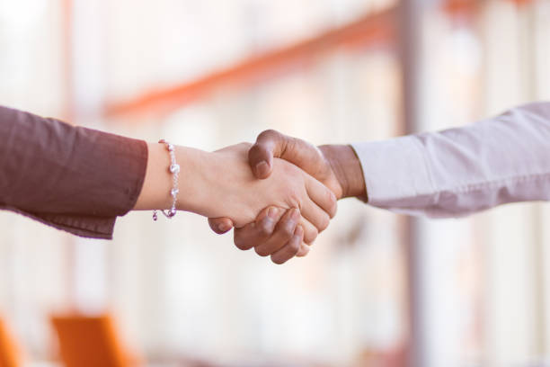 istock Handshake between african and a caucasian man. 1188099955