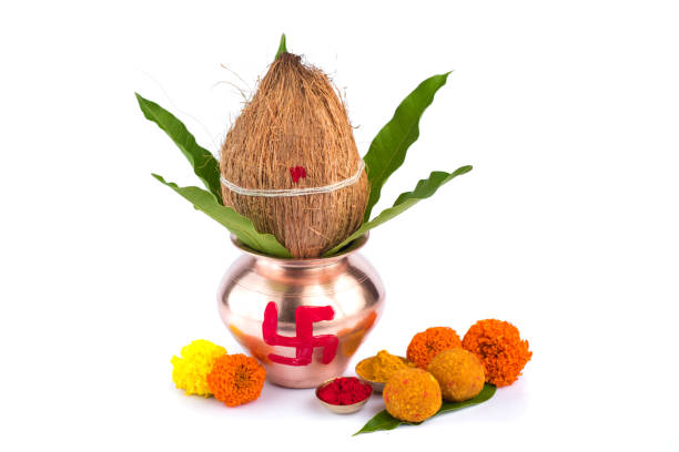 istock Copper Kalash with coconut, mango leaf, Haldi, kumkum and sweets with marigold flower decoration on a white background. Essential in Hindu puja. 1188100005
