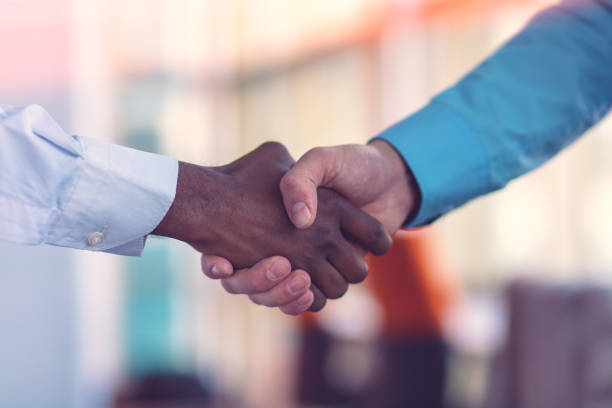 istock Handshake between african and a caucasian man. 1188101039