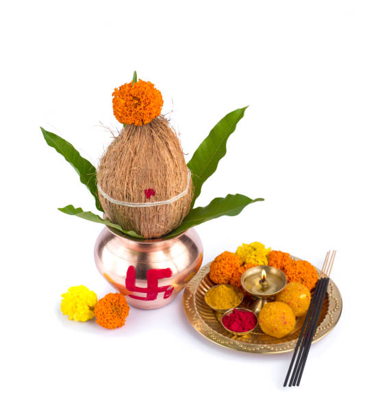 istock Copper Kalash with coconut and mango leaf and pooja thali with diya, kumkum and sweets with floral decoration on a white background. Essential in hindu puja. 1188101130